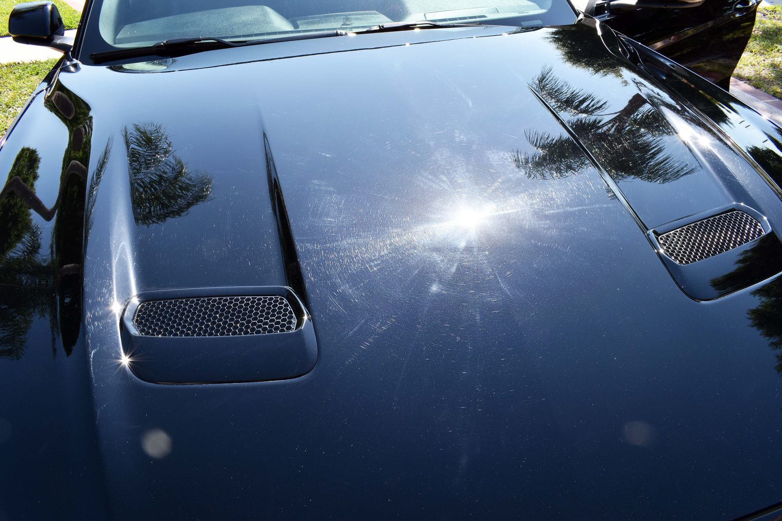 2018 Ford Mustang GT hood before paint correction, showing swirl marks and holograms